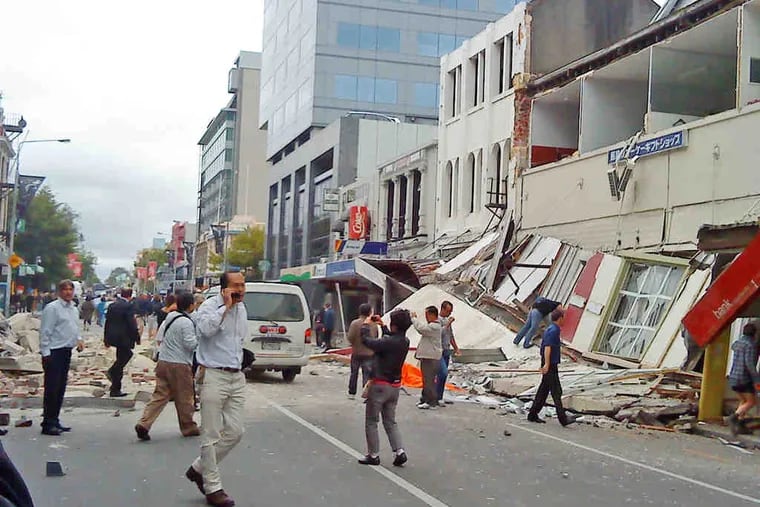 Stunned survivors walk among the collapsed buildings Tuesdayin Christchurch, a city of 350,000. The 6.3-magnitude quake left at least 300 missing. It was among the worst in 80 years.