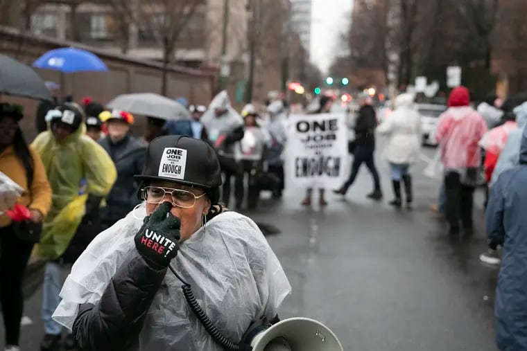 Earlene Bly of Unite Here Philly chants into a megaphone during a rally outside of the Wyndham Hotel at Fourth and Arch Streets in Philadelphia in March, just before the city went into lockdown. Philadelphia City Council passed a package of bills that will provide job security to the union's members, as well as nonunion hospitality workers.
