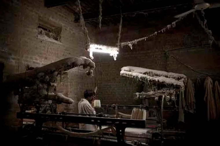 A man works in a textile factory in Faisalabad, a city in Punjab province, where power outages had cut industrial output 25 percent. One fear is that job losses could make workers militant.