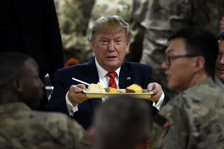 US President Donald Trump serves Thanksgiving dinner to US troops at Bagram Air Field during a surprise visit on November 28, 2019 in Afghanistan.