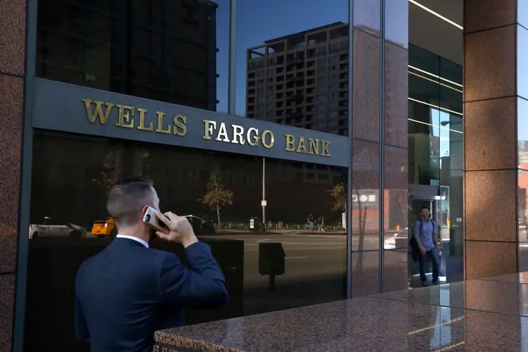 A pedestrian walks past a Wells Fargo bank in downtown Los Angeles.