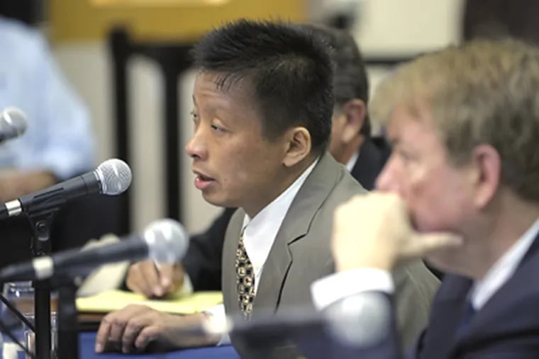 Dr. Gary Kao, left, answers questions from Sen. Arlen Specter at the Philadelphia Veterans Hospital during field hearings on the VA's terminated cancer treatment program today in Philadelphia. Looking on at right is Dr. Gerald Cross, Acting Under Secretary for Health, department of Veterans Affairs. (AP Photo/Bradley C Bower)