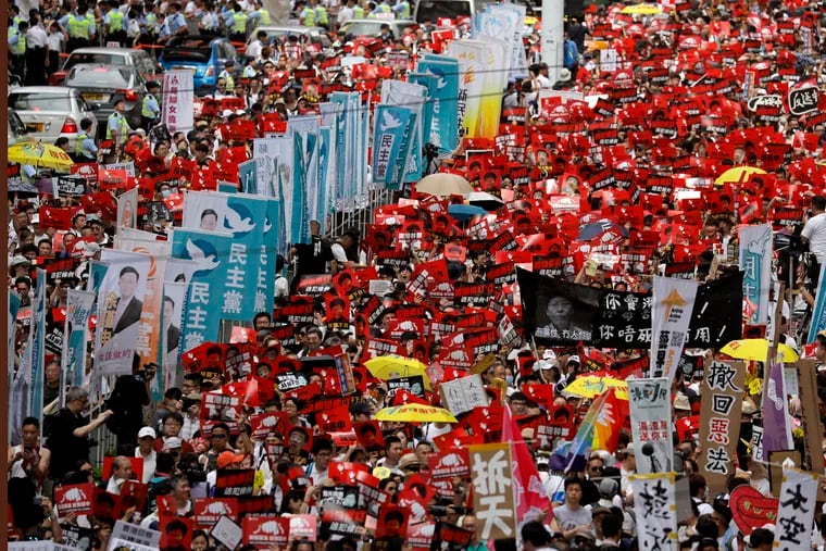 Protesters march along a downtown street against the proposed amendments to an extradition law in Hong Kong on Sunday.