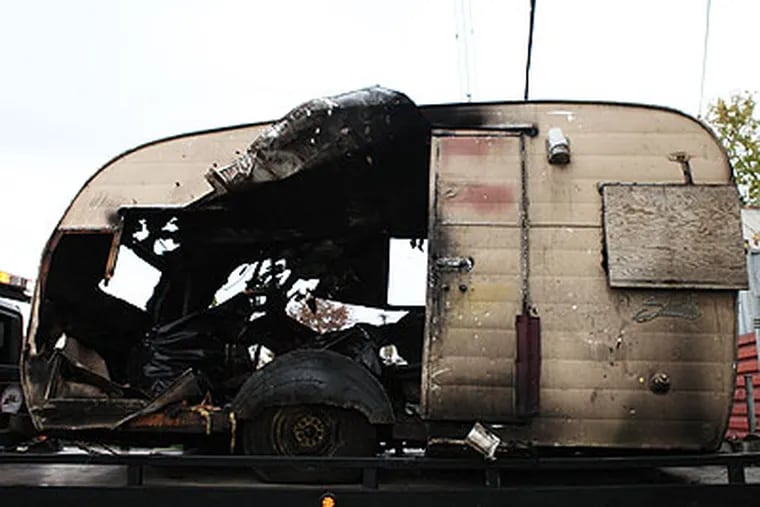 The remains of a trailer in which a fire broke out Thursday night in Camden, killing mechanic Orlando Arroliga, a legal resident originally from Nicaragua. (Juliette Lynch / Staff Photographer)