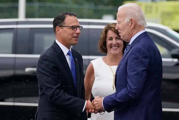 President Joe Biden greets now-Gov. Josh Shapiro, left, and Terese Casey, wife of Sen. Bob Casey as he arrives at Wilkes-Barre Scranton International airport in August 2022.