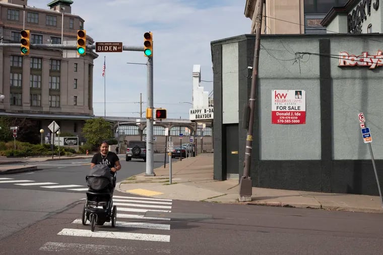 A pedestrian crosses at the intersection of Biden Street and Lackawanna Avenue in downtown Scranton, Pa.