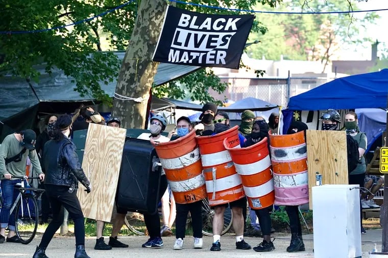 Activists gather at 22nd and The Parkway, in preparation for a possible eviction from the encampment by the city, in Philadelphia, August 18, 2020.