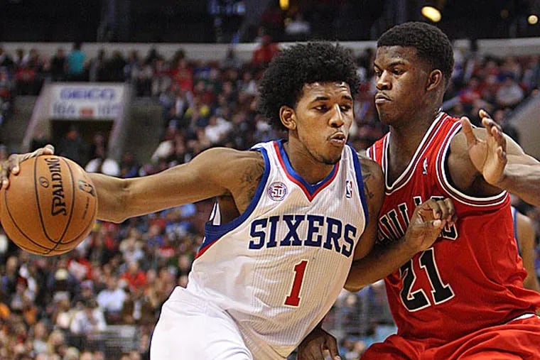 Sixers guard Nick Young drives on the Bulls' Jimmy Butler during the fourth quarter. (Steven M. Falk/Staff Photographer)