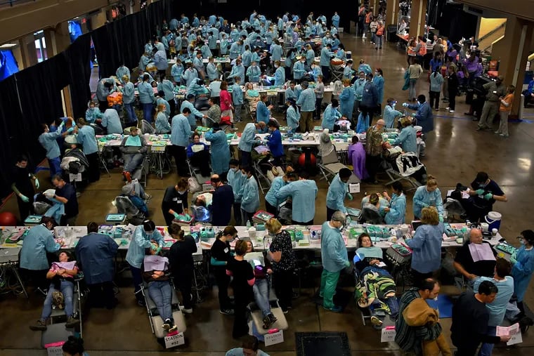 Scores of patients and dentists pair up at the Remote Area Medical free clinic in Knoxville, Tenn. The all-volunteer group delivers medical, dental and vision care services in underserved, isolated, or impoverished communities around the country and world.