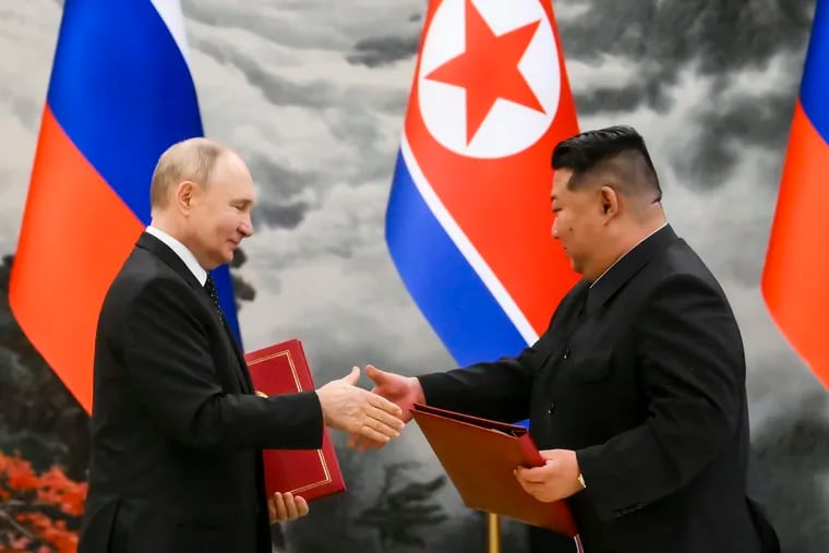 Russian President Vladimir Putin, left, and North Korea's leader Kim Jong Un exchange documents during a signing ceremony of the new partnership in Pyongyang, North Korea, on Wednesday, June 19, 2024.