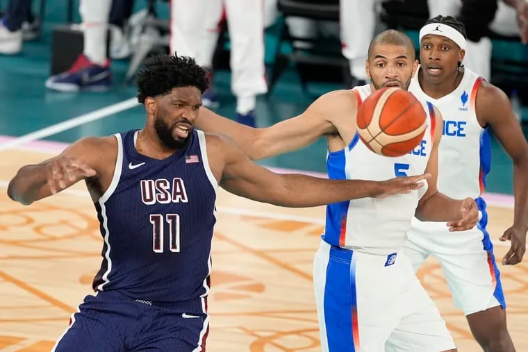 Joel Embiid (11) battles former Sixers teammate Nico Batum for the ball in the Olympic gold-medal game. It was Embiid's first Games playing for Team USA. Was it also his last?