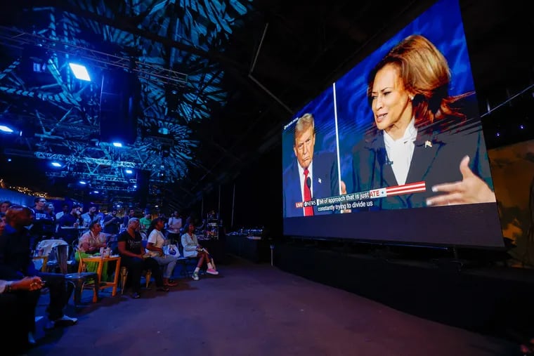 People watch the debate at a Dems watch party at the Cherry Street Pier in Philadelphia, Tuesday, Sept. 10, 2024.