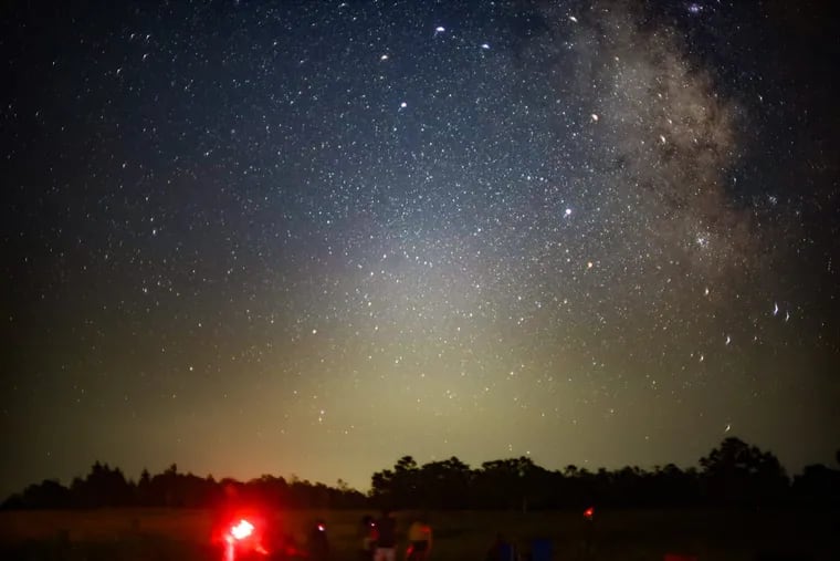 Stargazers, some using less intrusive red lights as flashlights, observe the sky and Perseid meteor shower last August in Shenandoah National Park in Virginia.