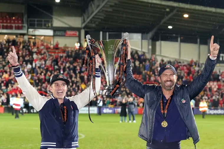 Philly's Rob McElhenney (left) with Wrexham AFC co-owner Ryan Reynolds after the team won England's National League soccer championship in April.