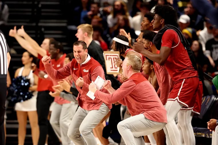 Coach Adam Fisher (center) of Temple and the bench celebrate during a game against Drexel in November.