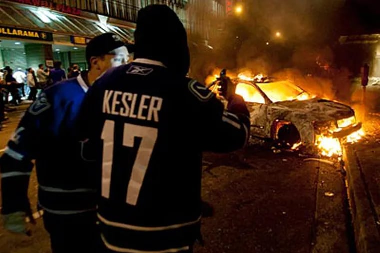 Fans take part in a riot in Vancouver after the Canucks fell in the Stanley Cup Finals. (AP Photo/The Canadian Press, Ryan Remiorz)