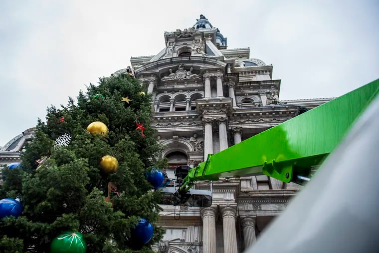 A crew from Proof Productions decorate the City's holiday tree at City Hall in Philadelphia, Pa, on Nov. 22, 2019.