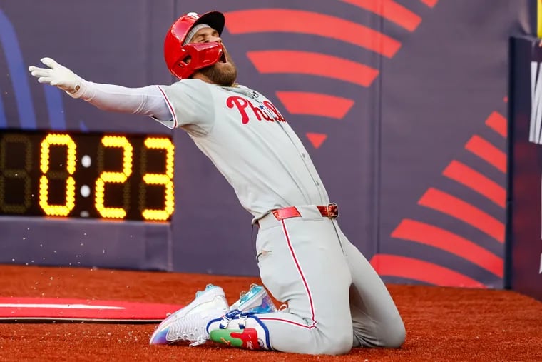 Phillies Bryce Harper celebrates a solo home run with a soccer style knee slide during the fourth inning against the Mets at London Stadium on June 8.