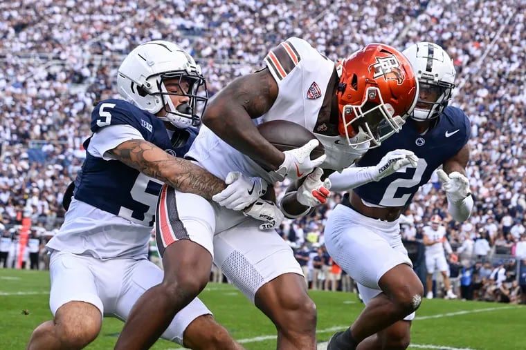 Bowling Green wide receiver Malcolm Johnson Jr. (center) is tackled by Penn State cornerback Cam Miller on Saturday. The Nittany Lions allowed 375 total yards in a close call.