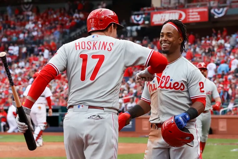 Jean Segura celebrates with Rhys Hoskins after scoring in the Phillies' six-run ninth inning on Friday.