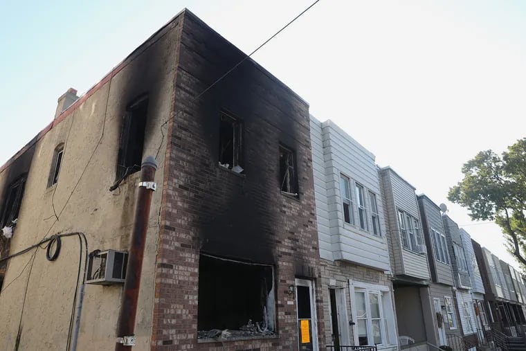 A burned-out home is pictured in the 1500 block of Sotuh 30th Street in Philadelphia's Grays Ferry section on Saturday, Nov. 21, 2020. Two children were killed and four others hospitalized after a fire broke out overnight.