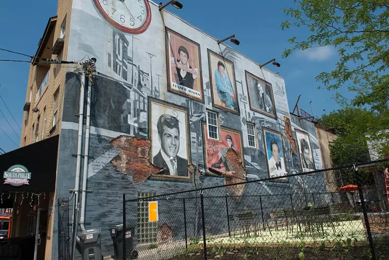 The mural, near Pat's King of Steaks at Ninth Street and Passyunk Avenue, will come down, but it might be replaced elsewhere with the same images of homegrown stars. (MICHAEL PRONZATO/Staff Photographer)