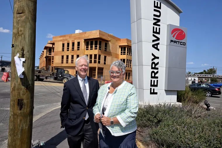 Virtua Our Lady of Lourdes Hospital chief medical officer Alan Pope (left) and Lisa Ferraro (right), president of Virtua Our Lady of Lourdes Hospital, pose on Monday, Sept. 9, 2024, as construction continues on a building with affordable senior rental units and a first-floor Virtua facility next to the Ferry Avenue PATCO station in Camden.