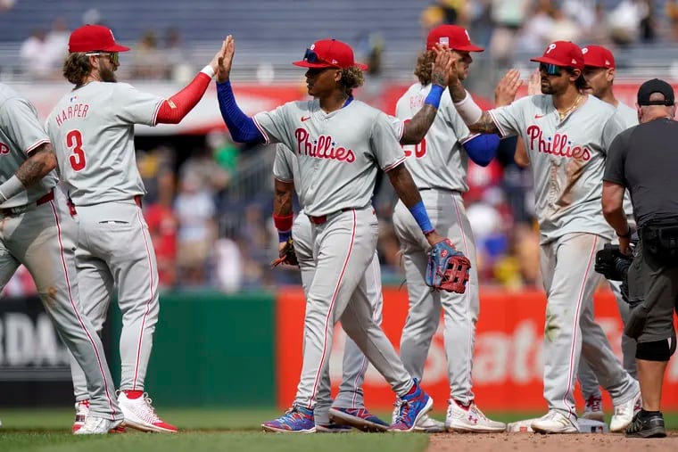 Philadelphia Phillies players celebrate after defeating the Pittsburgh Pirates in a baseball game Sunday, July 21, 2024, in Pittsburgh. (AP Photo/Matt Freed)