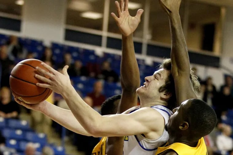 Archbishop Carroll grad Ryan Daly is having a good freshman year playing for Carroll grad Martin Inglesby at Delaware. He goes up for a shot through mulitple Drexel defenders on Feb. 16, 2017. CHARLES FOX / Staff Photographer