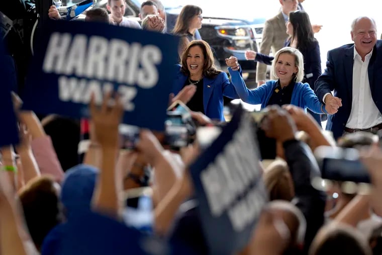 Democratic presidential nominee Vice President Kamala Harris (left), Democratic vice presidential nominee Minnesota Gov. Tim Walz (right), and his wife, Gwen Walz, arrive at Pittsburgh International Airport, Sunday, Aug. 18, 2024, in Pittsburgh. (AP Photo/Julia Nikhinson)