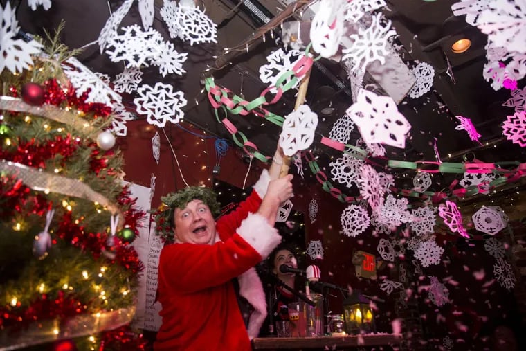 Joe Gunn, co-owner of Jose Pistola's, stands amid a sea of thousands of paper snowflakes, an annual part of the Jose Pistola's Christmas Smackdown Bar Crawl.