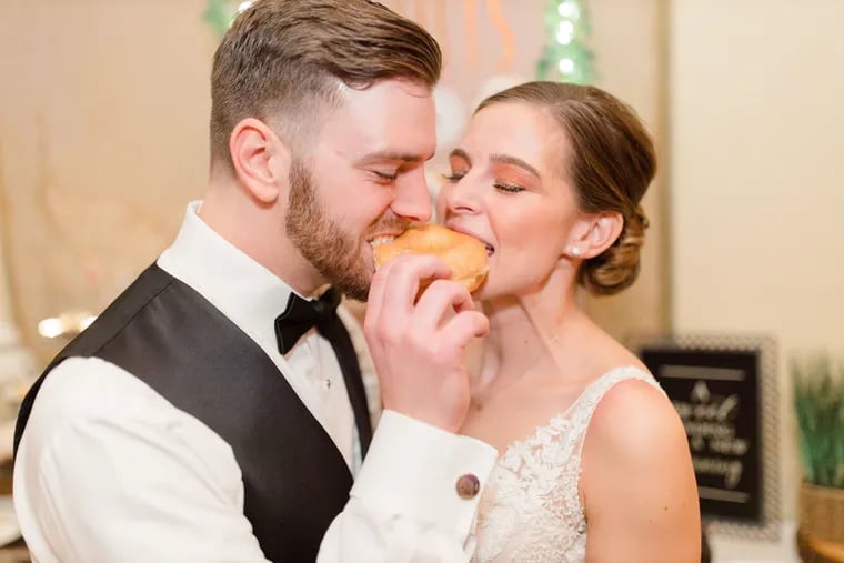 Anthony Kulik and Bernadette Costello share a donut on their wedding day