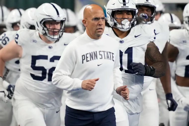 FILE - Penn State head coach James Franklin, center, runs out with his team before an NCAA college football game against Michigan State, Nov. 24, 2023, in Detroit. Mississippi will play for the first 11-win season in school history when the Rebels of the Southeastern Conference, led by quarterback Jaxson Dart, face Penn State, led by quarterback Drew Allar, in the Peach Bowl, Saturday, Dec. 30, 2023. (AP Photo/Carlos Osorio, File)