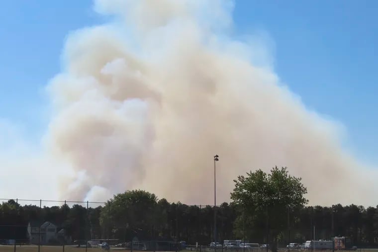 Large plumes of smoke rise from a forest fire in Berkeley Township, N.J., on Tuesday.