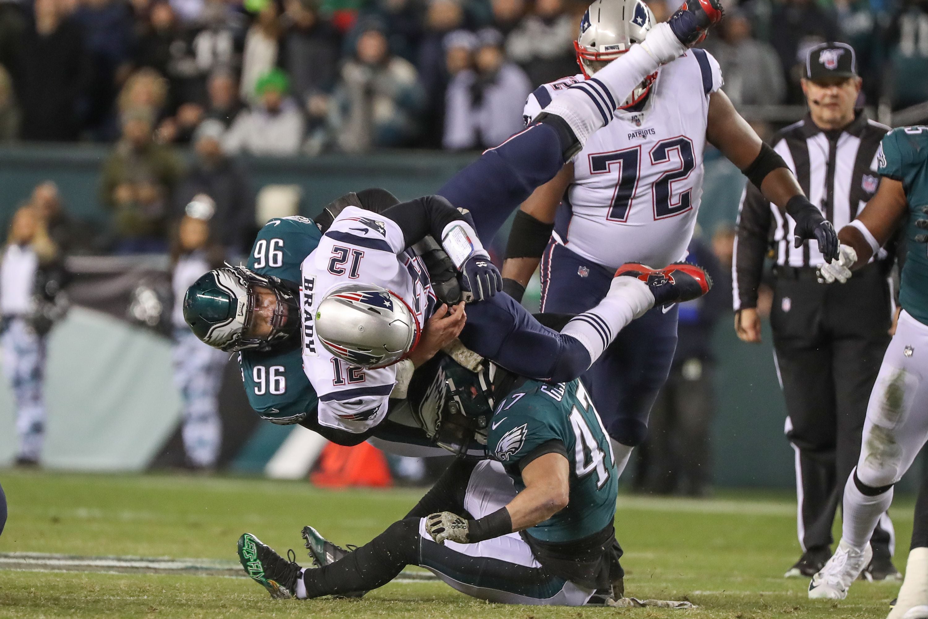 New England Patriots quarterback Tom Brady sits dejectedly near the Super  Bowl logo after losing a fumble late in the fourth quarter against the Philadelphia  Eagles in Super Bowl LII at U.S.