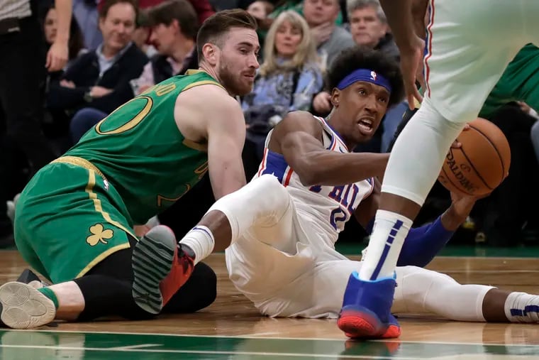 76ers guard Josh Richardson controls the ball during a floor scramble against Celtics forward Gordon Hayward, left.