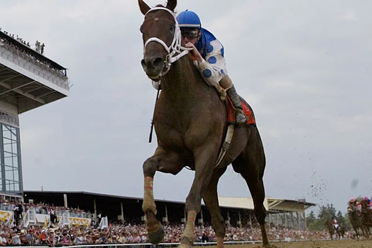Smarty Jones with Stewart Elliott up leads the field to win the Preakness in Baltimore on Saturday, May 15, 2004. (Al Behrman/AP file)