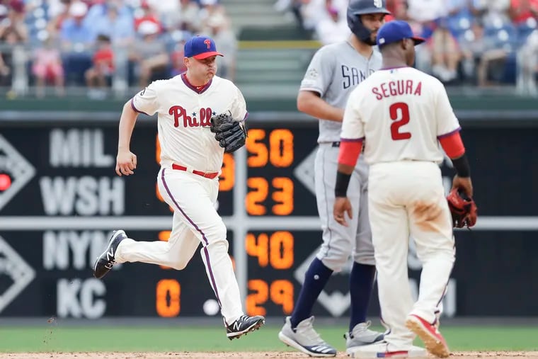 Phillies pitcher Jared Hughes sprints toward the pitchers mound with Phillies shortstop Jean Segura and San Diego Padres Eric Hosmer wait at second base in the sixth-inning on Sunday, August 18, 2019 in Philadelphia.  Hughes replaced starting pitcher Jason Vargas.