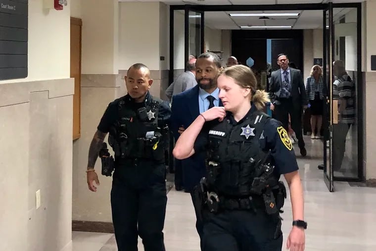 Kevin Morgan is escorted from a courtroom by Montgomery County Sheriff's deputies on Monday during a break from his trial on first-degree murder and related crimes.