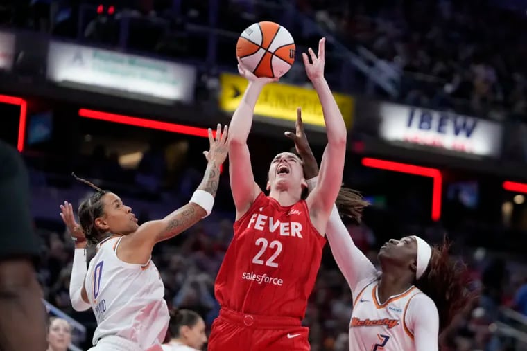 Philly's Natasha Cloud (left) and Kahleah Copper (right) of the Phoenix Mercury defend Indiana Fever's Caitlin Clark during an Aug. 16 matchup.