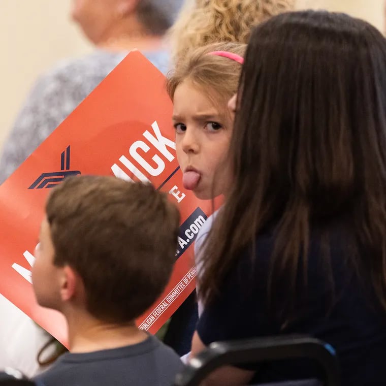 A young girl sticks her tongue out at members of the media at an event for Dave McCormick, Republican candidate for the Senate, at a GOP event at the Bucks County Republican Committee in Doylestown.