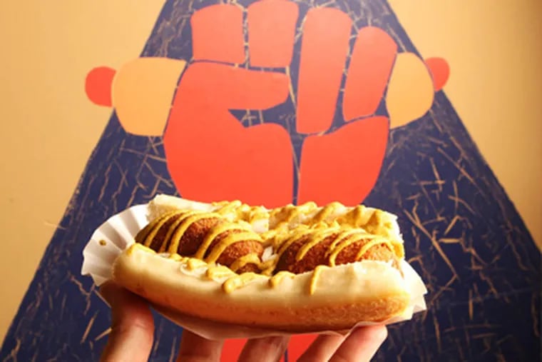 "The Back in the Day" from Underdogs features a hot dog with fish cakes and onions laced with mustard.   ( Charles Fox / Staff Photographer )