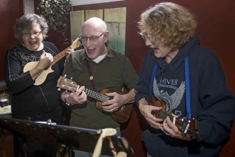 Betsy Manning (from left), Mal Whyte, and Anne Stevenson Smith rock out as they sing and perform "Monster Mash" in the Green Fork Diner in North Wales on Sunday.