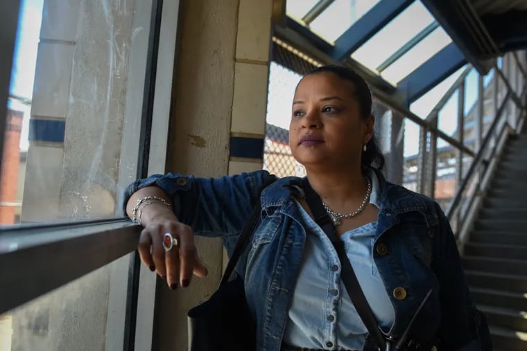 Roz Pichardo looks out the window at Kensington Avenue from inside the Somerset El station on April 27, 2019. Pichardo is a Kensington resident who works in the harm reduction community in the neighborhood.