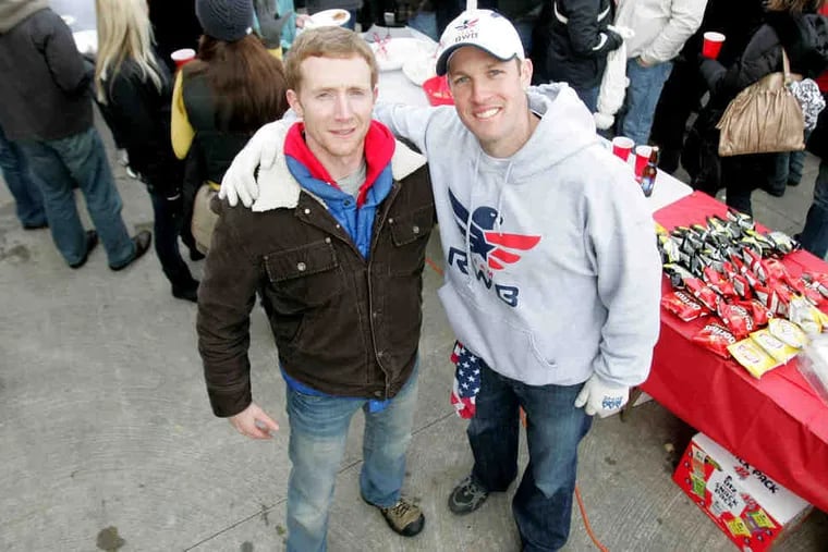 Sam Linn and Mike Erwin (right) at the tailgate fund-raiser at the Army-Navy game. They aim to assist veterans reentering society.