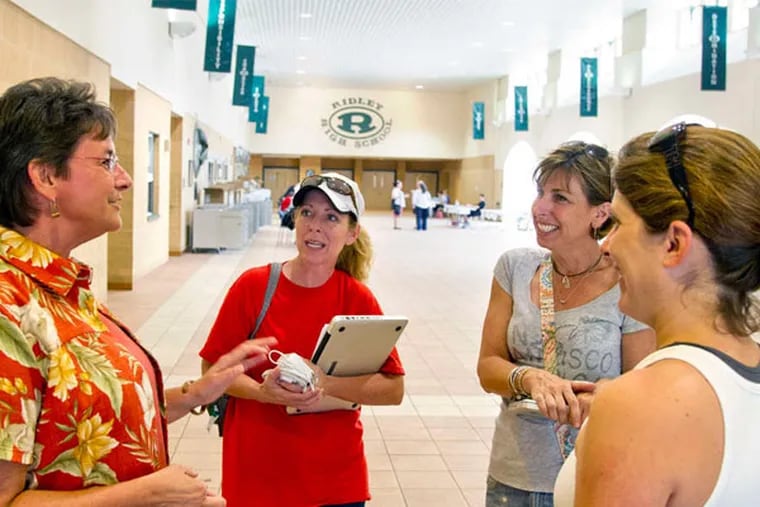 Ridley School District Superintendent Lee Ann Wentzel (left) talks with (from left) teachers Laura Stiefel, Christine Toth, and Jenn Scaramuzza-Fisher. Millages in the district have almost doubled since the 2003-04 school year, adding about $1,900 to the median tax bill. Despite the increases, a deficit has forced the district to drop 12 teaching positions.