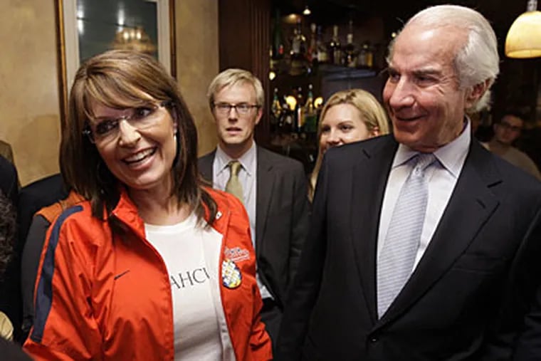 Alaska Gov. Sarah Palin, seen with Ed Snider (right), chairman of Comcast-Spectacor, visited the Irish Pub, on 20th and Walnut streets, last night before the start of the presidential debate. (AP)
