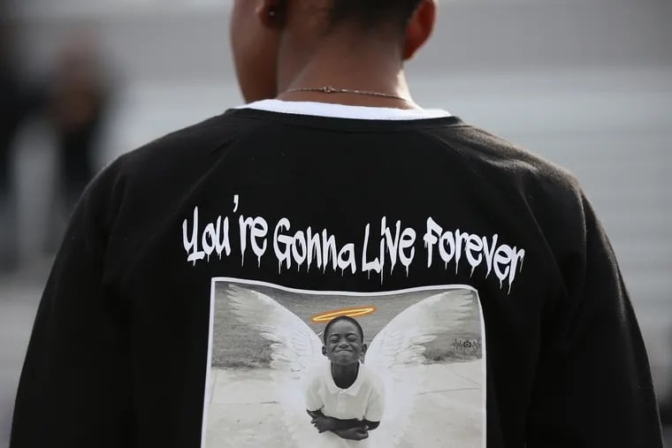 Pleasantville High School freshman class president Khaliyah Haraksin wears a t-shirt memorializing 10-year-old Micah Tennant before she speaks.