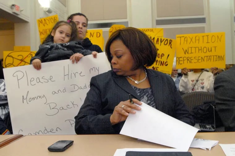 In February 2011, a laid-off police officer and her family confront then-Mayor Dana Redd at a heated meeting at Camden City Hall.