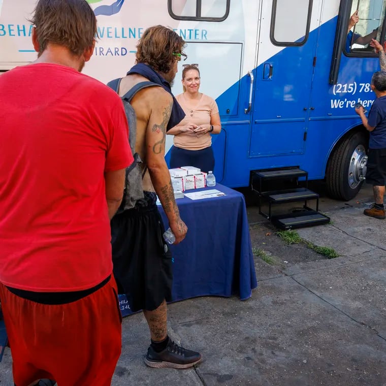 In this 2023 file photo, people along Kensington Avenue walk past the mobile home belonging to the Behavioral Wellness Center at Girard parked along Kensington Avenue. The Behavioral Wellness Center at Girard parked their Winnebago along Kensington Avenue to assist those living with addiction find inpatient and outpatient care.